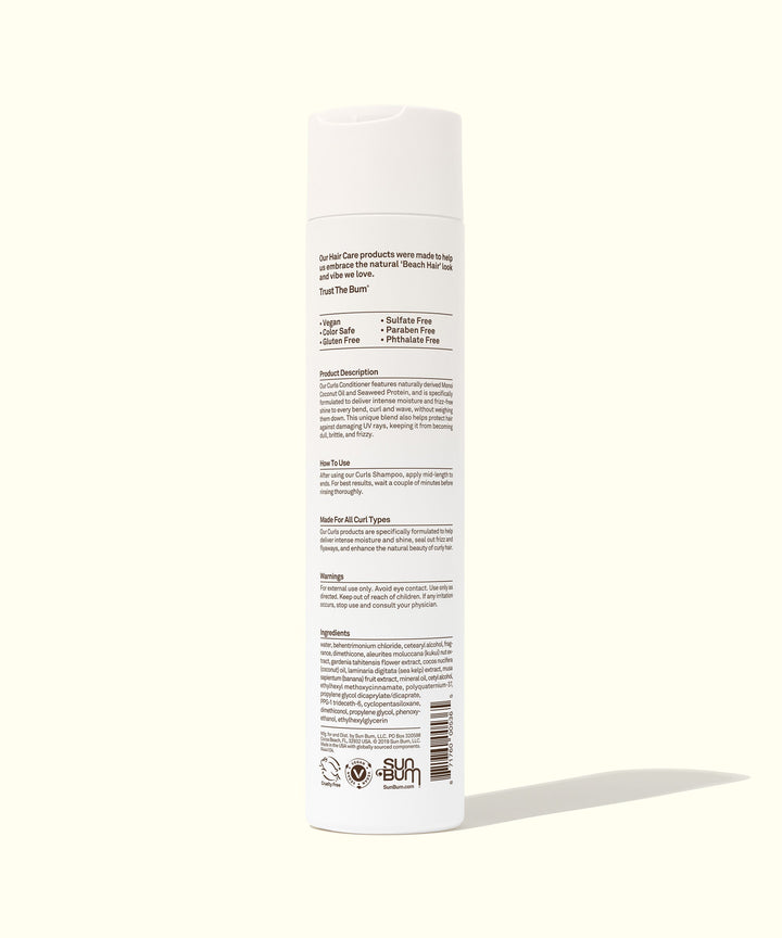 Back view of a white bottle of Curls Conditioner featuring ingredients and usage instructions. Ideal for curly hair, used Kukui Nut Oil and Monoi Coconut Oil. Sun Bum.