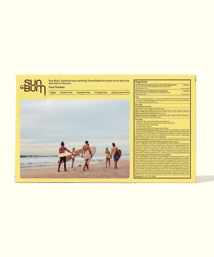 Group of friends with surfboards on a beach, sun care essentials by Sun Bum.