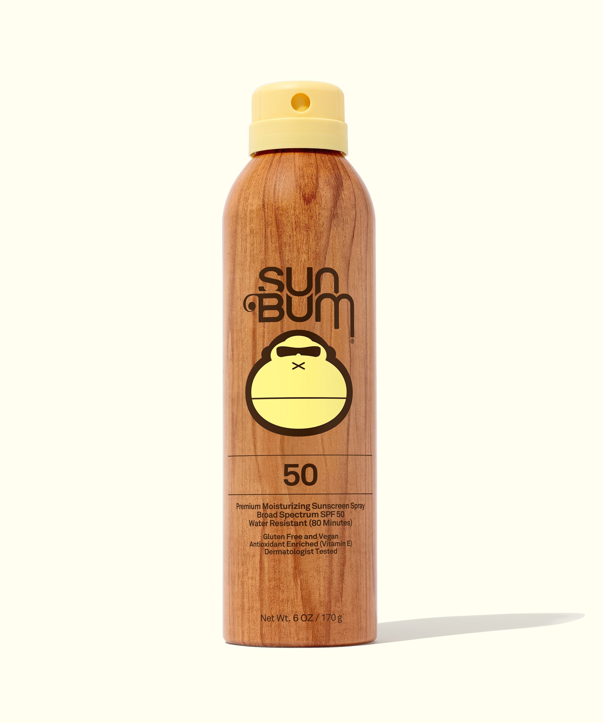 Original SPF 50 Sunscreen Spray in wooden-look container with yellow cap, provides broad spectrum protection, enriched with Vitamin E. Non-aerosol compression, no chemical propellants. Sun Bum,