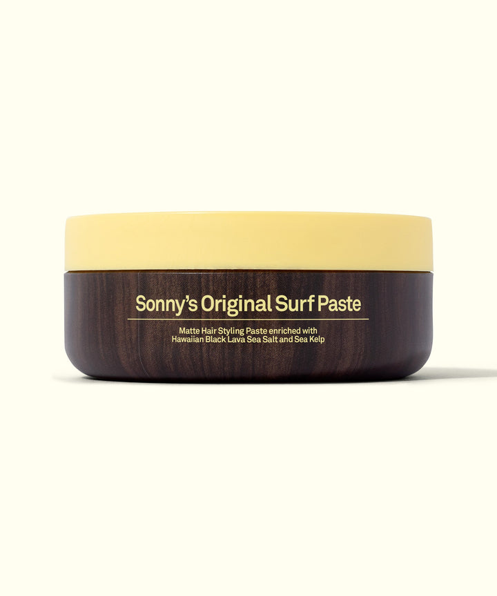 Image of Sonny's Original Surf Paste in a sleek, round container with a yellow lid, perfect for short hair to achieve a stylish look effortlessly. Sun Bum.