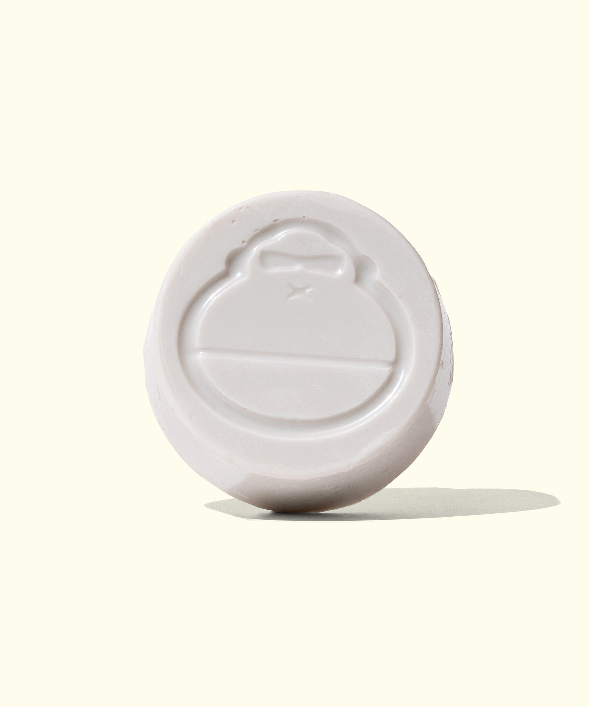 Round bar of cool-water surf wax, imprinted with a logo, ideal for enhancing grip while surfing. Sun Bum,