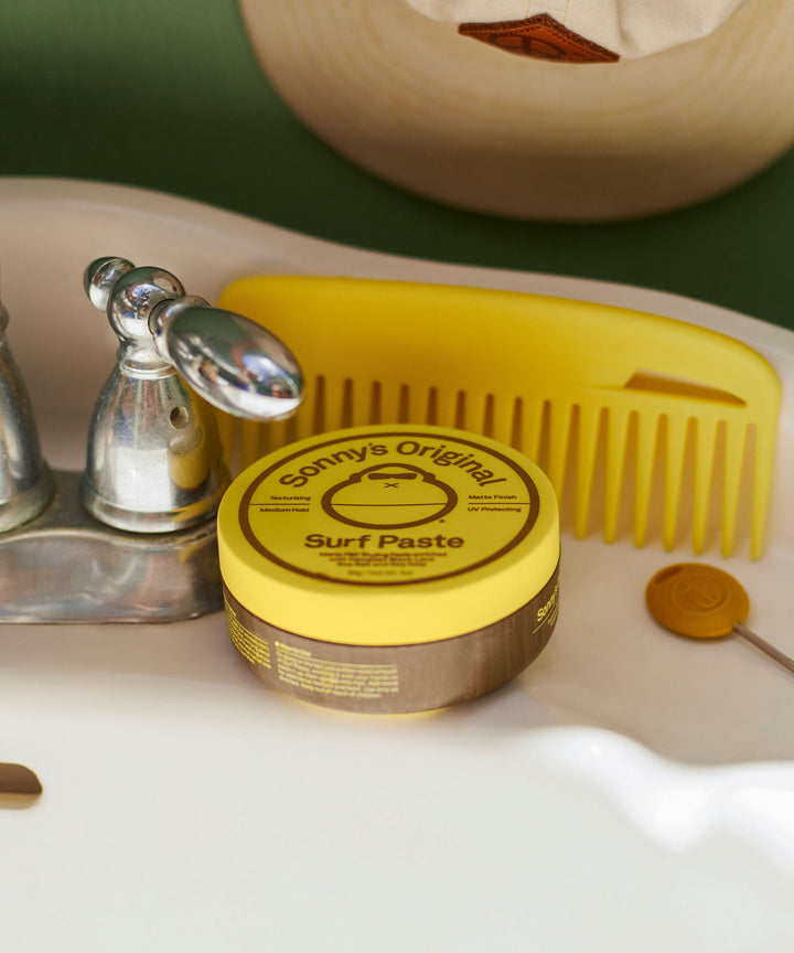 Sonny's Original Surf Paste on bathroom sink with yellow comb, Sun Bum,