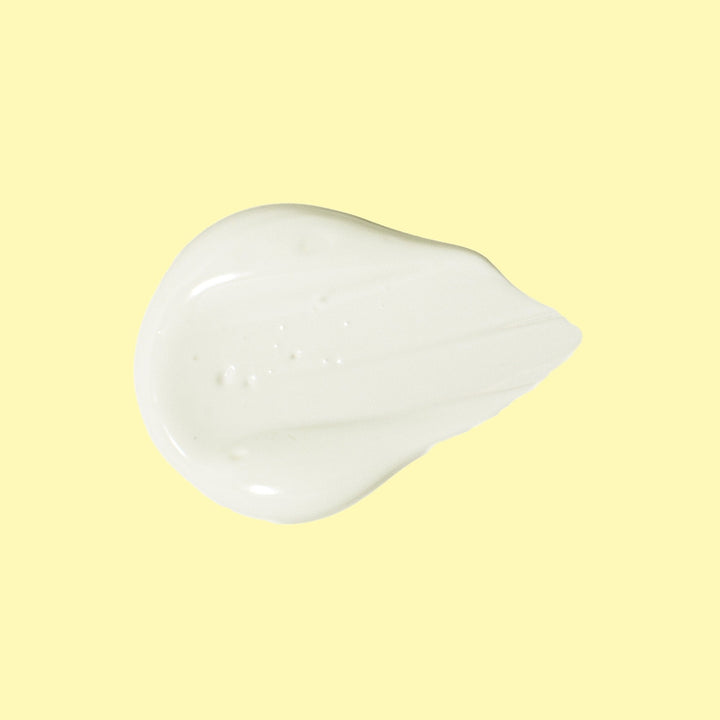 A dollop of smooth, creamy Original SPF 70 Sunscreen Lotion against a light yellow background. Sun Bum